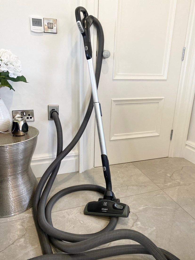 Beam Central Vacuum hose stood against white living room door