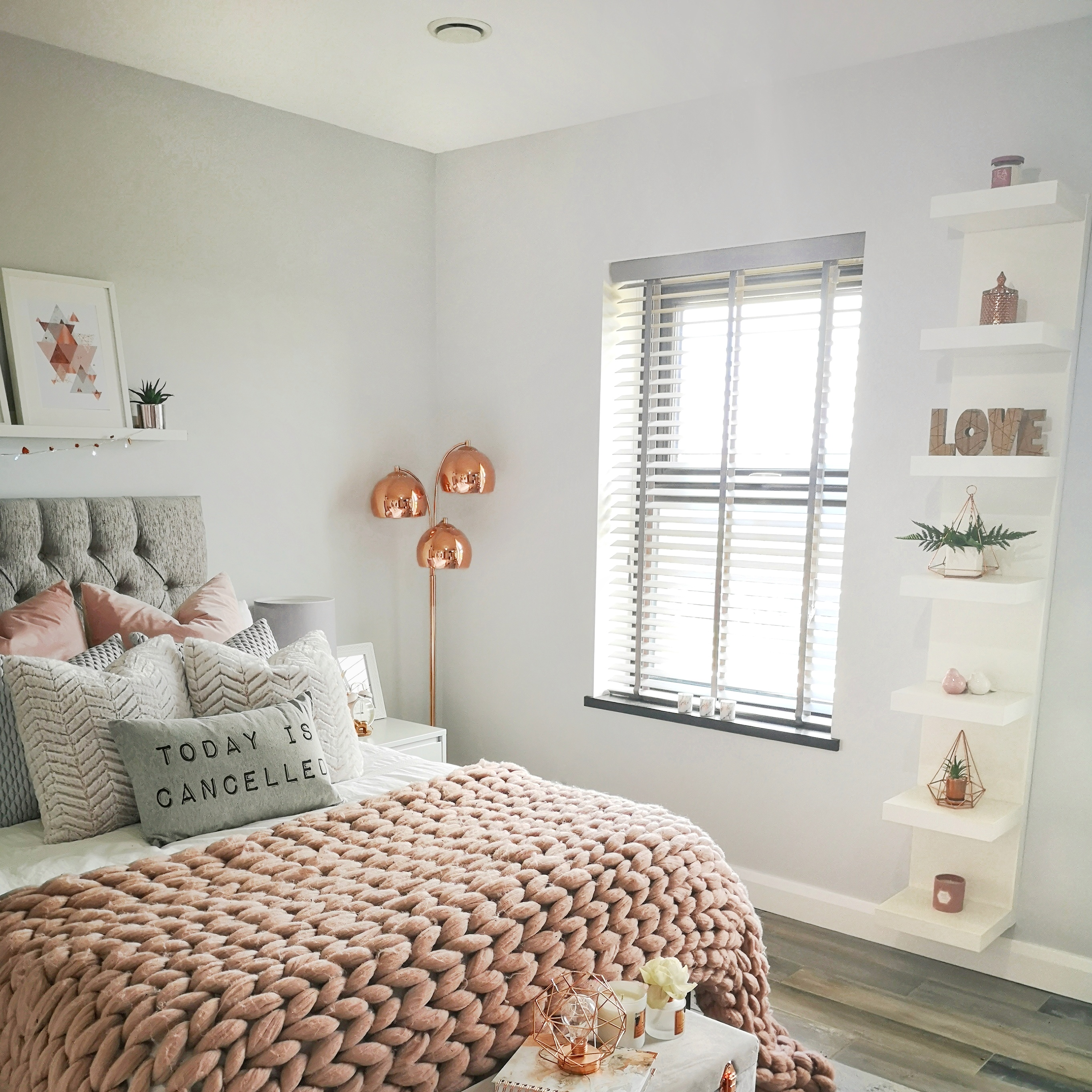 Pink and grey bedroom with mechanical ventilation valve on ceiling