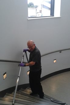 Man Vacuuming Stairs with Beam Central Vacuum