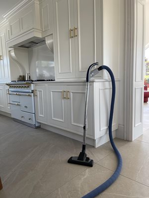 Beam Retractable Hose propped against kitchen cabinet