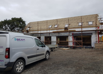Beam van in front of house at roofing stage