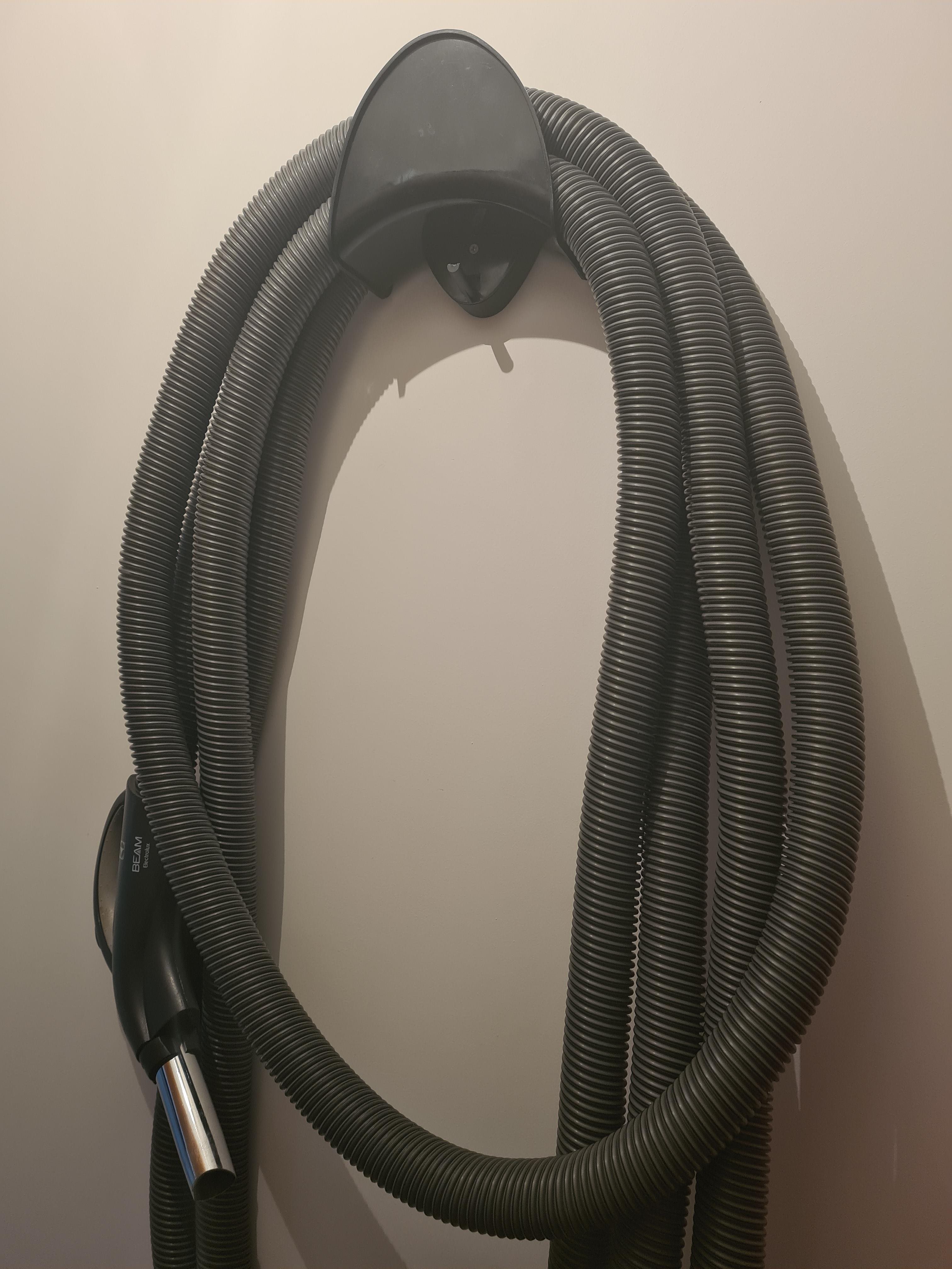 Beam Central Vacuum hose on hanger on wall