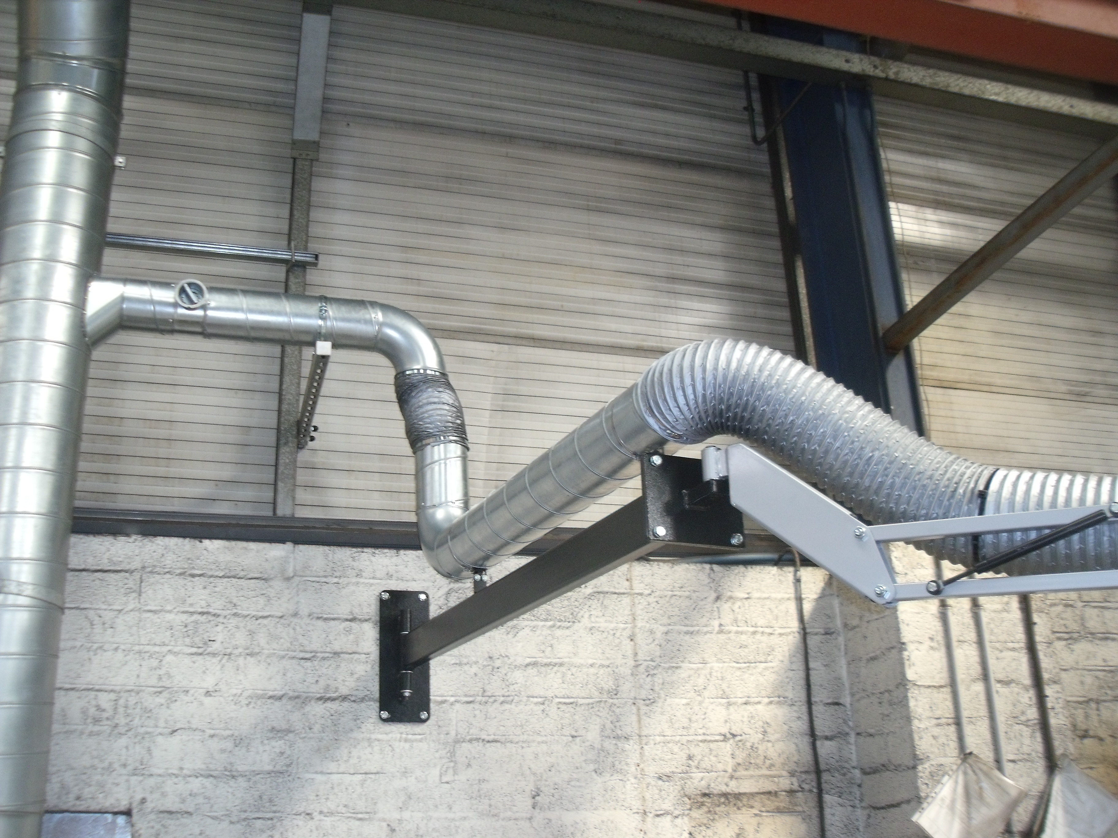 2m silver extension boom attached to factory wall