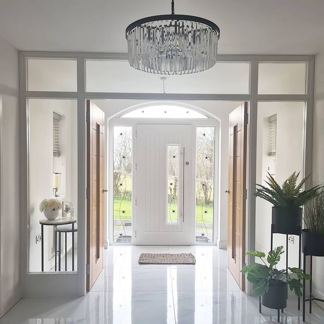 Marble hallway with plants & chandelier