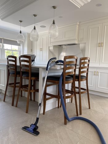 Beam Retractable Hose propped against kitchen island