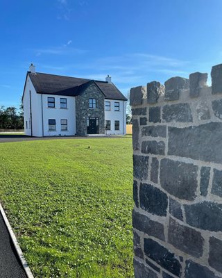@countryhomeni-house-with-wall-in-the-foreground